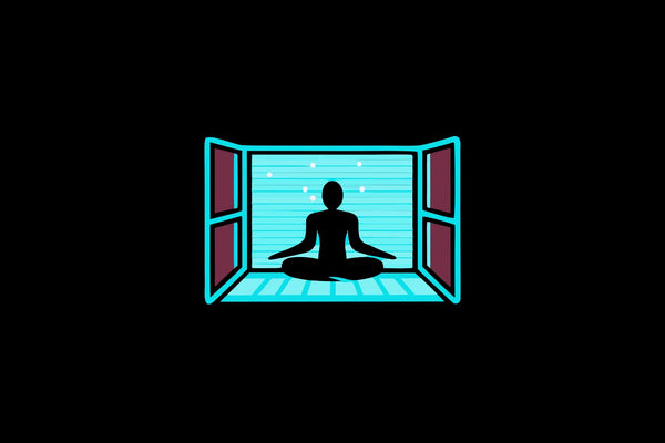 Person meditating in a wellness studio bathed in soft red, blue, and full-spectrum light therapy panels