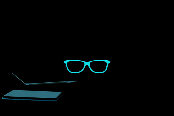 Blue light glasses that may work for sleep, shown with a laptop and phone.
