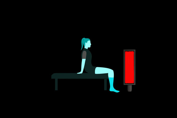 Woman using red light therapy for muscle recovery.