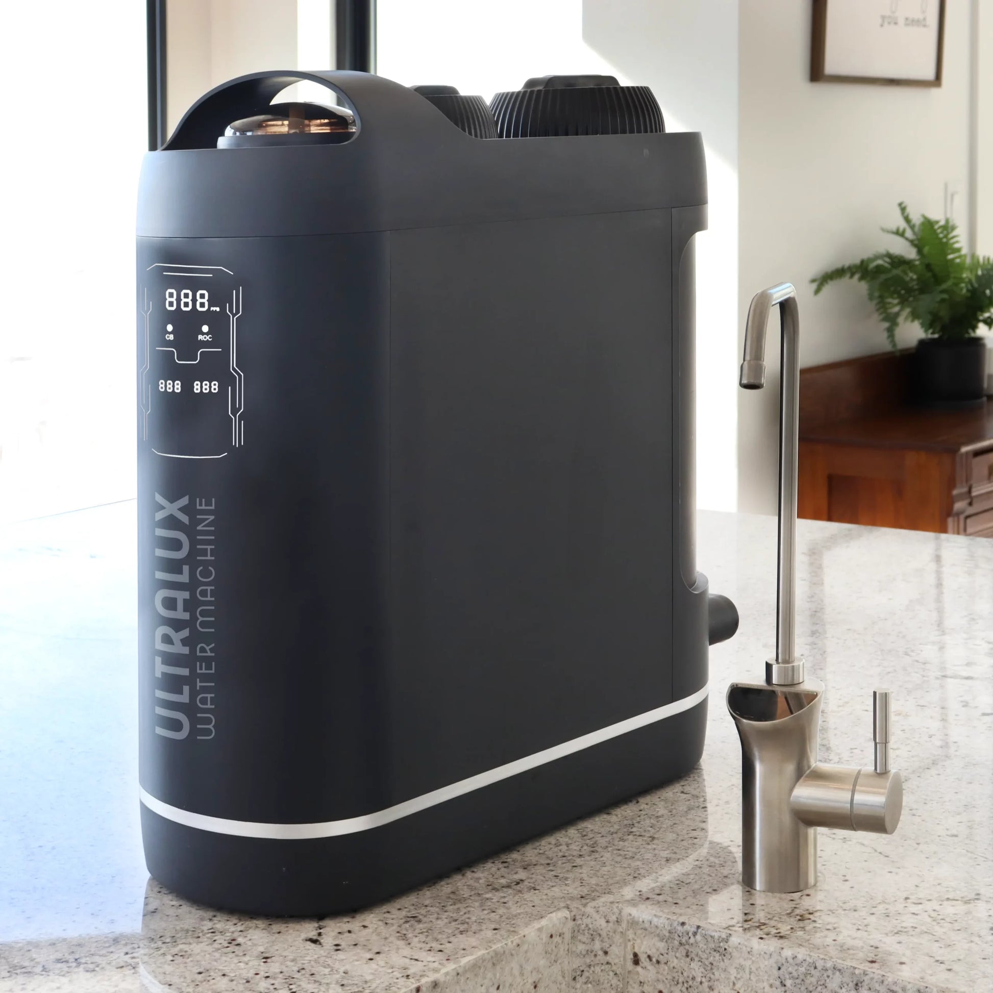 The UltraLux Water Machine, the best RO UV water filter, sitting on the counter next to the included digital faucet.
